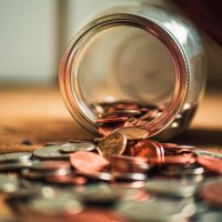 Debt advice for veterans and ex-forces in England, Wales and Northern Ireland - coins spilling from a jar