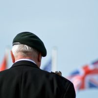 Financial and money advice for veterans and ex-forces - ex-service man in front of flag